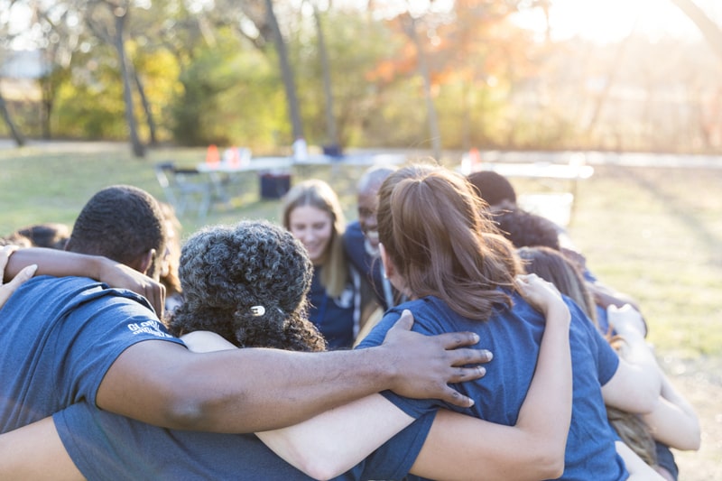 Volunteers huddle together