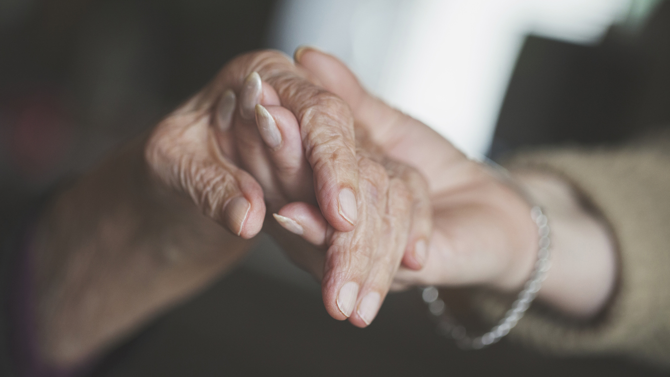 Holding hand of very old woman-home caregiver